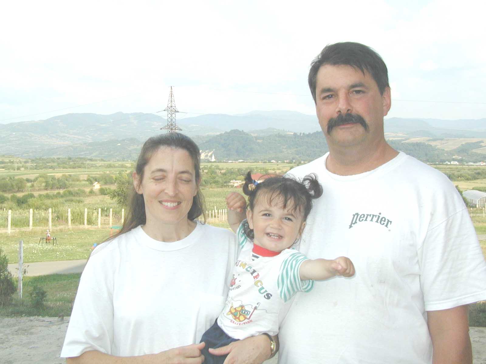 Phyllis Ann and Michael with a child at Bistritia.